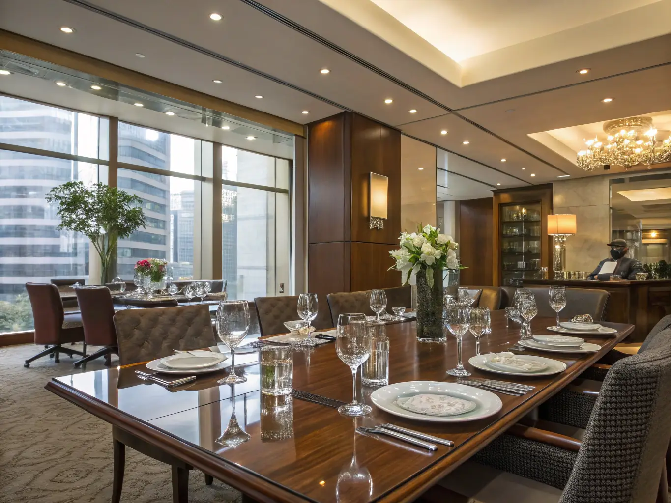 Executives participating in a strategic planning session in the formal dining room of Bluebell House, with large windows offering views of the surrounding landscape. The setting is conducive to focused discussion and innovative thinking, with ample space for presentations and group work.
